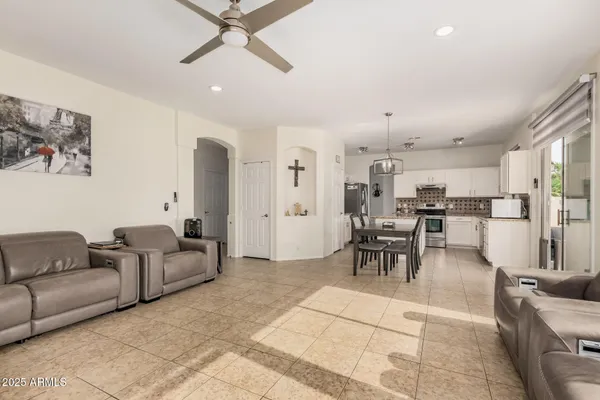 a living room with furniture and kitchen view