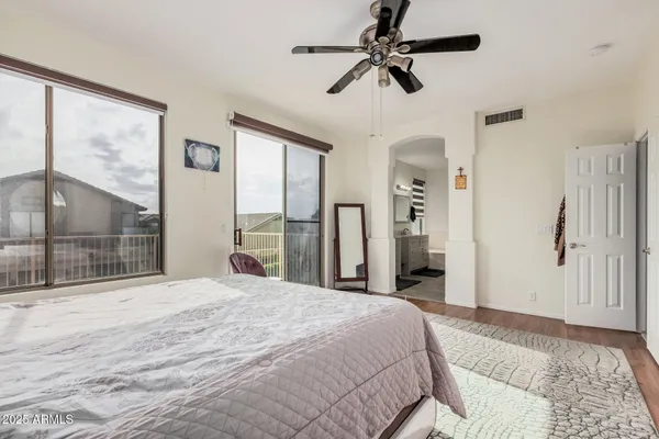 a bedroom with a large bed and a large window