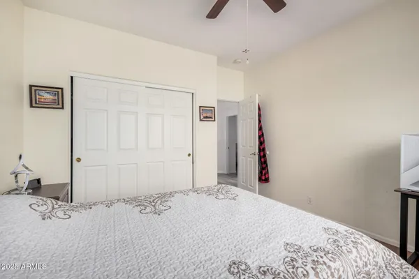 a bedroom with a bed and a large mirror