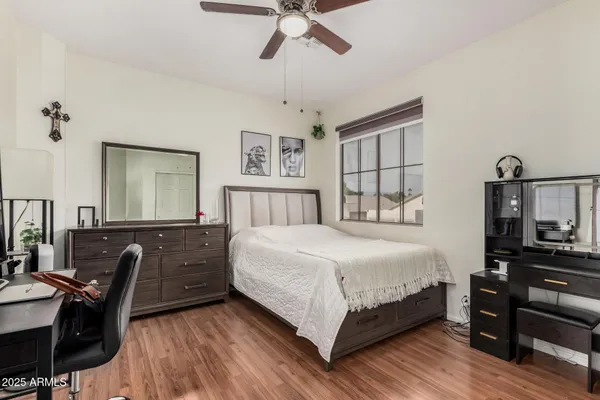 a bedroom with a bed window and a desk