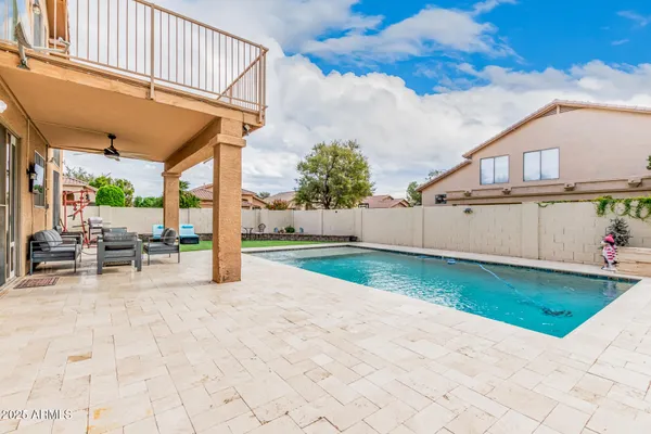a view of a backyard with sitting area