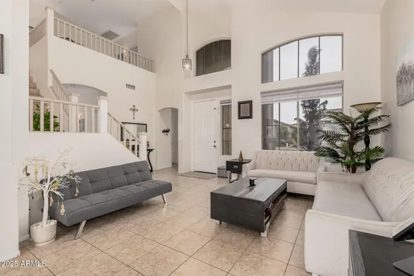 a living room with furniture and a potted plant
