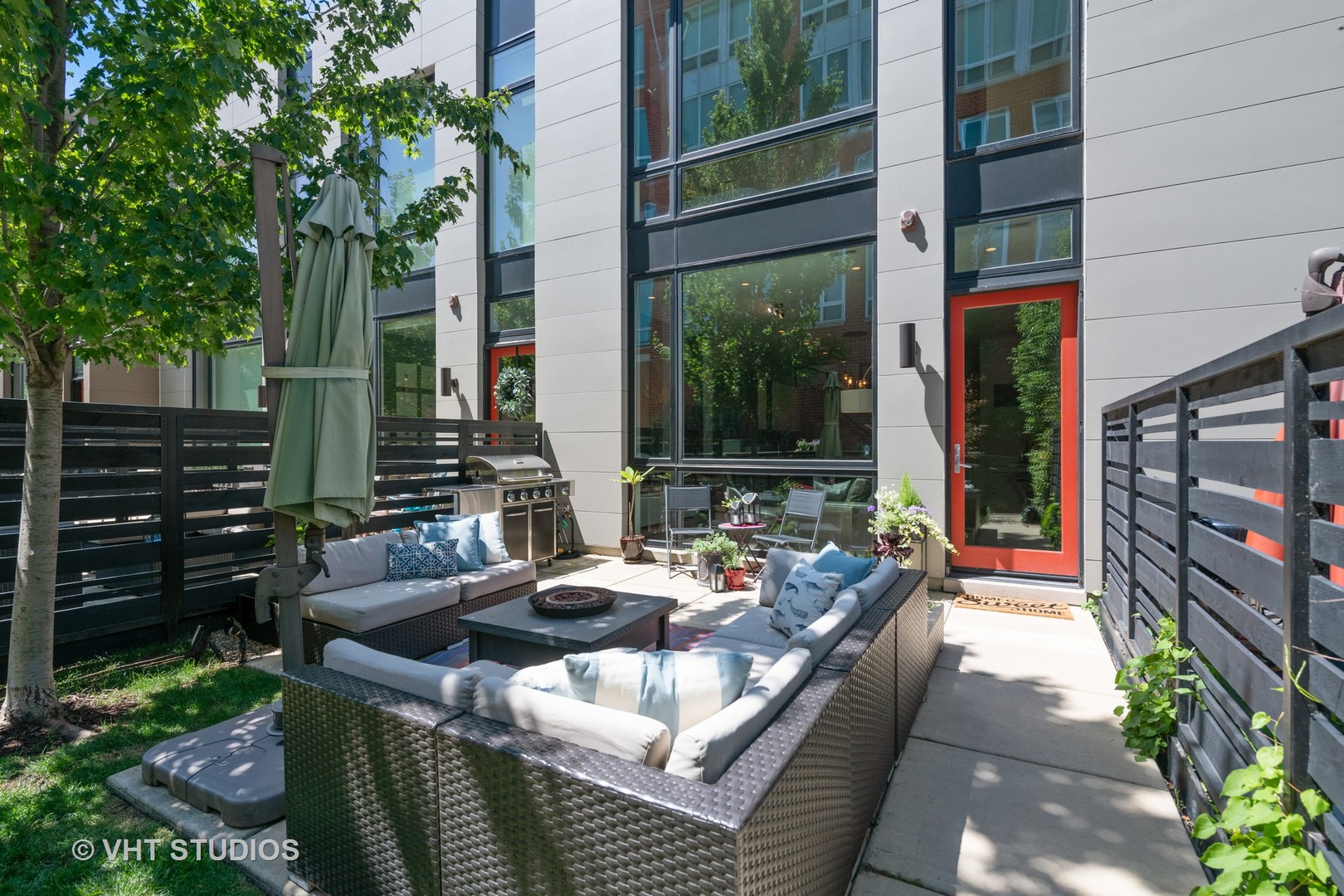 4832 North Clark Street, Unit 117 Chicago, IL 60640 - Photo 1 of 13 a outdoor space with patio the couches and potted plants