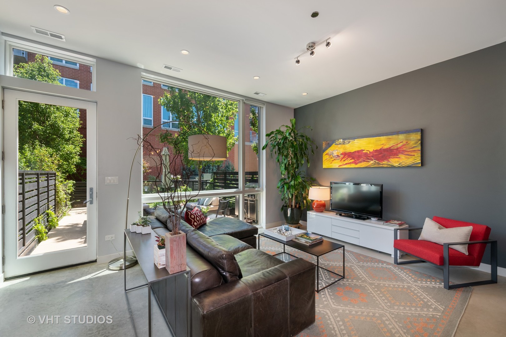 4832 North Clark Street, Unit 117 Chicago, IL 60640 - Photo 2 of 13 a living room with furniture and a flat screen tv