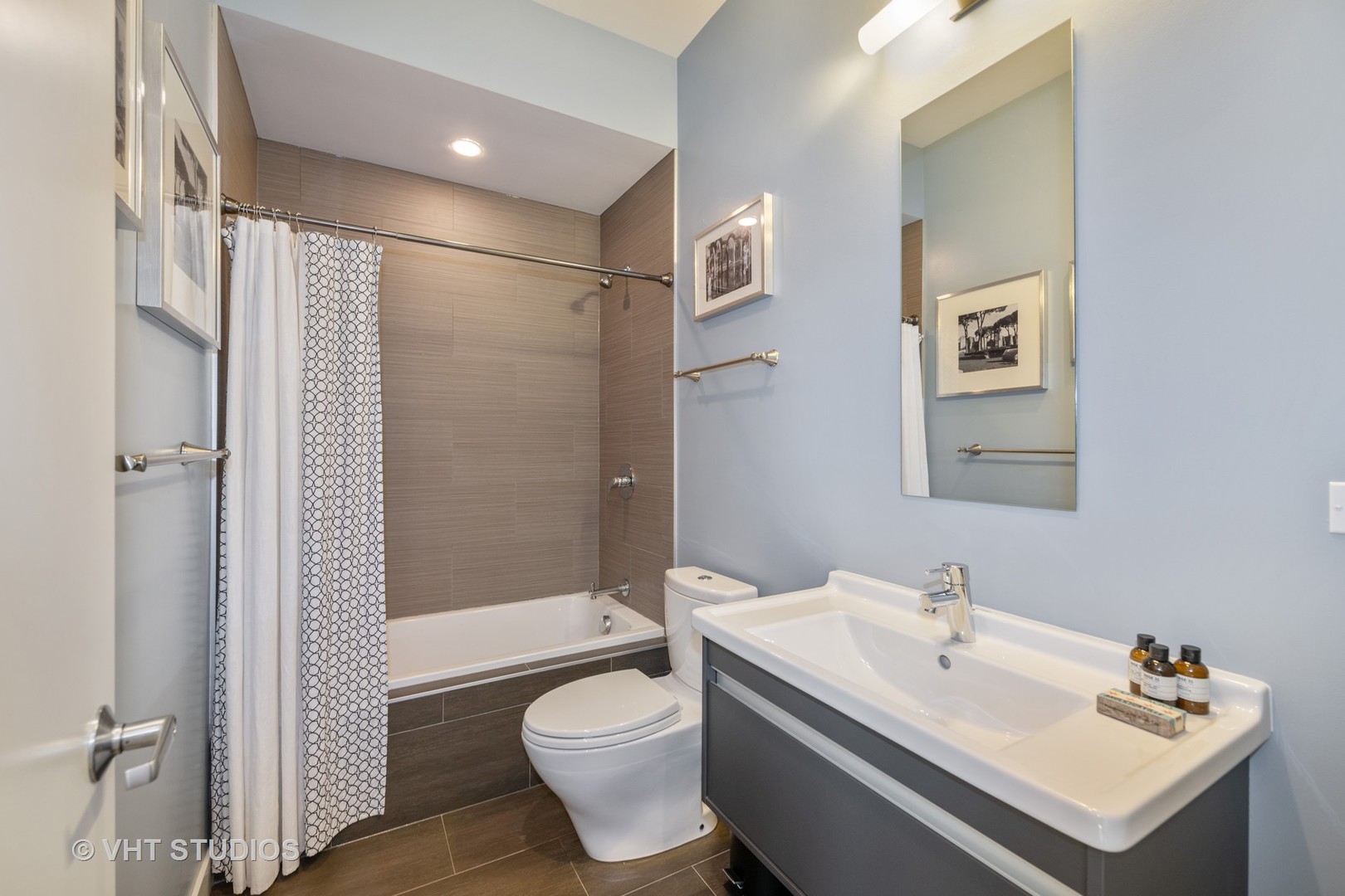4832 North Clark Street, Unit 117 Chicago, IL 60640 - Photo 11 of 13 a bathroom with a sink toilet and shower