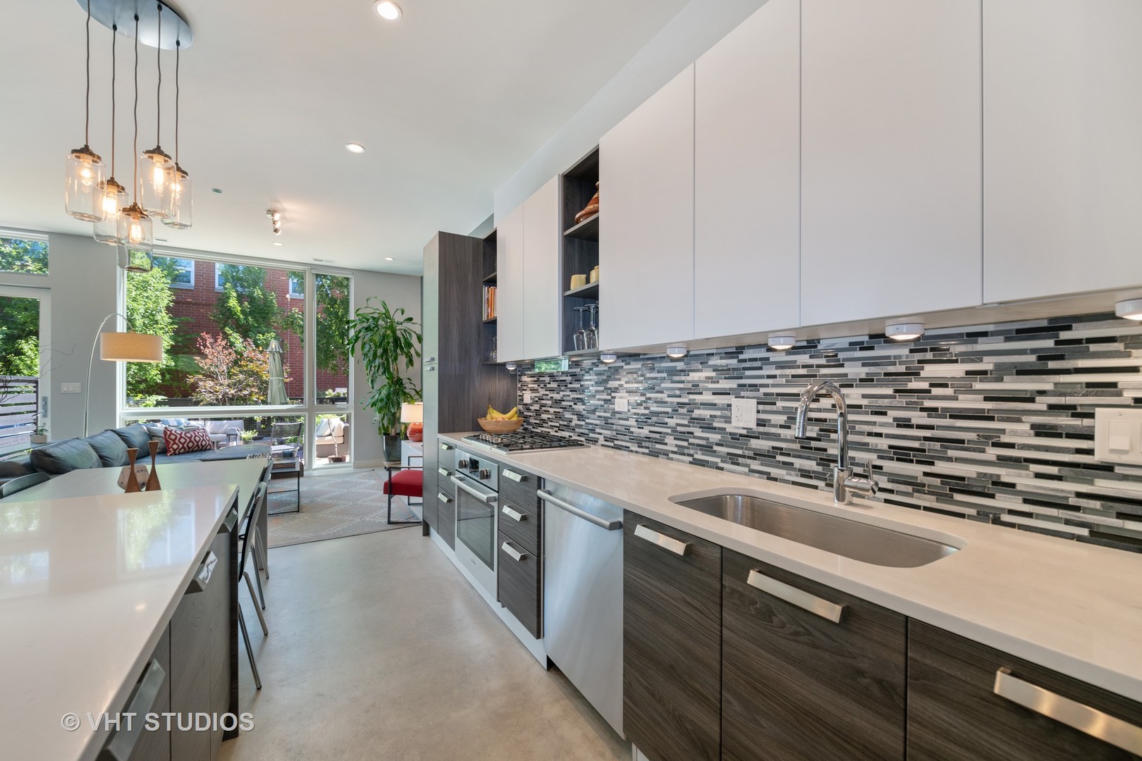 4832 North Clark Street, Unit 117 Chicago, IL 60640 - Photo 5 of 13 a kitchen with kitchen island stainless steel appliances a sink stove and cabinets