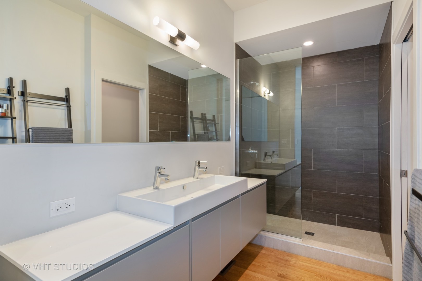 4832 North Clark Street, Unit 117 Chicago, IL 60640 - Photo 9 of 13 a bathroom with a double vanity sink mirror and shower