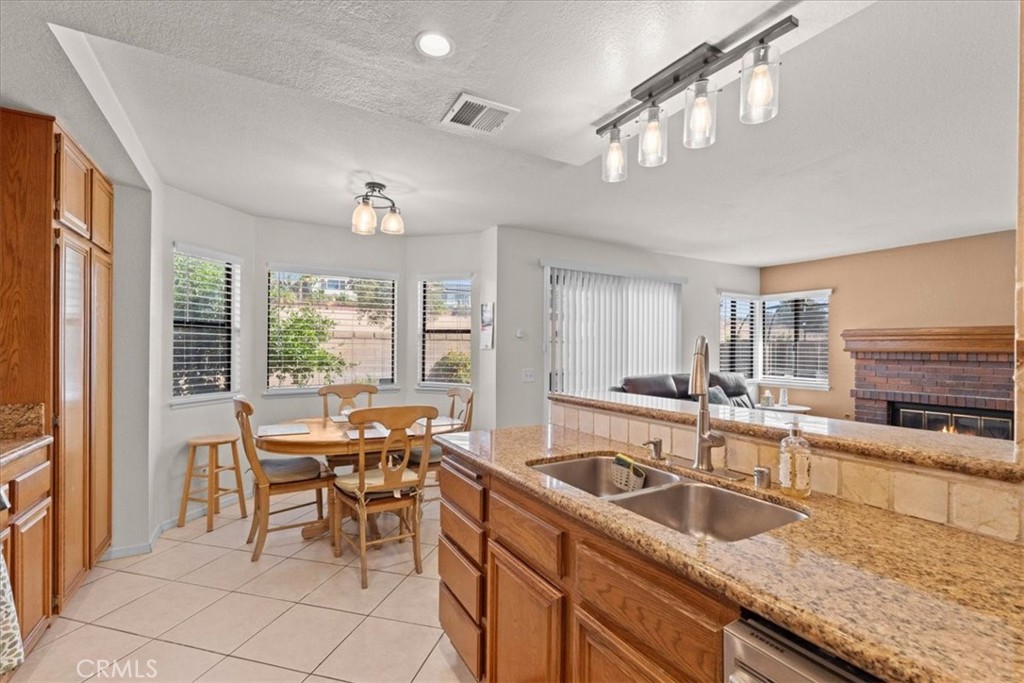 10536 Deerfield Drive Rancho Cucamonga, CA 91701 - Photo 12 of 28 a kitchen with granite countertop sink and cabinets