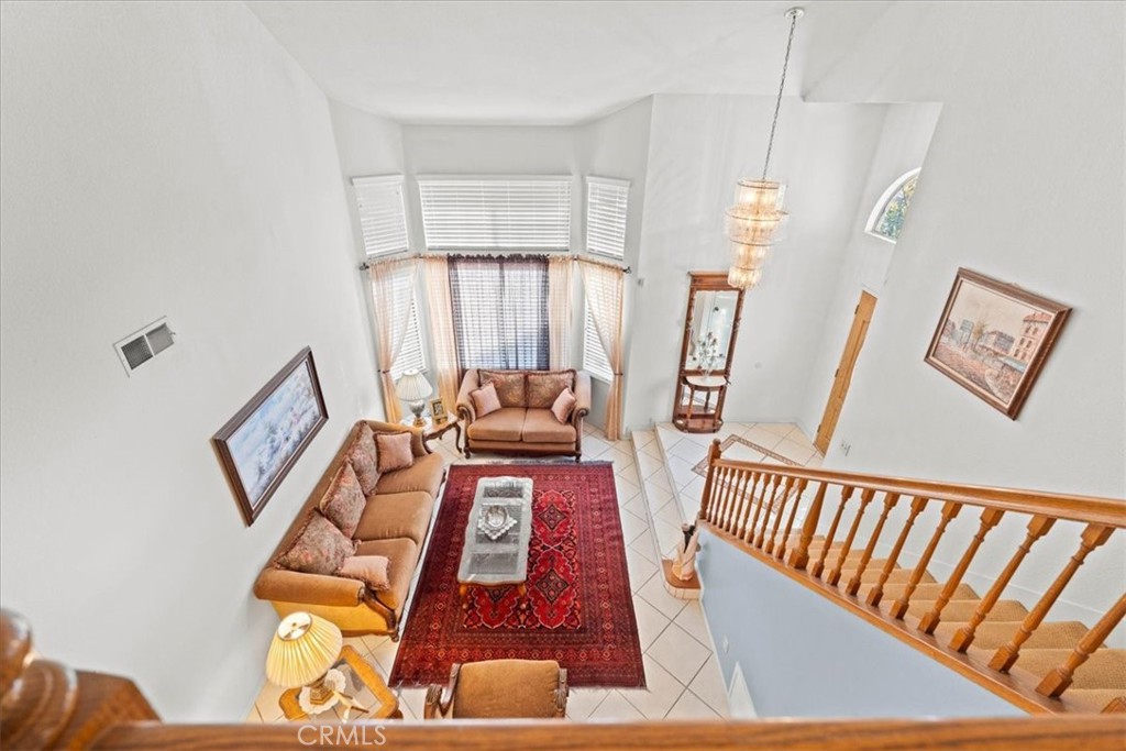 10536 Deerfield Drive Rancho Cucamonga, CA 91701 - Photo 15 of 28 a view of a hallway with furniture and wooden floor
