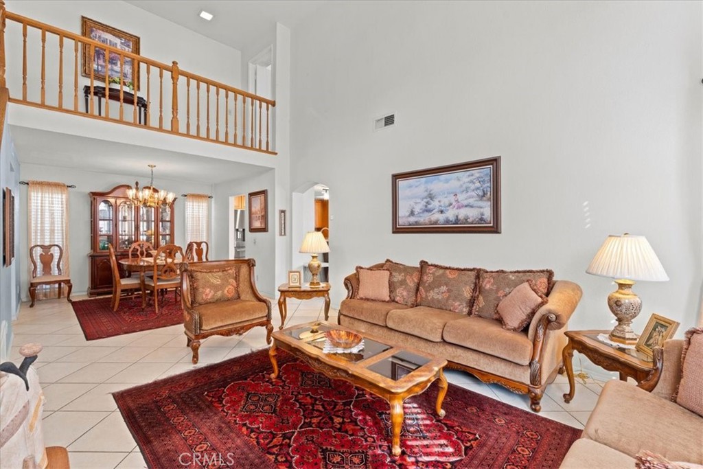 10536 Deerfield Drive Rancho Cucamonga, CA 91701 - Photo 2 of 28 a living room with furniture a rug and a lamp