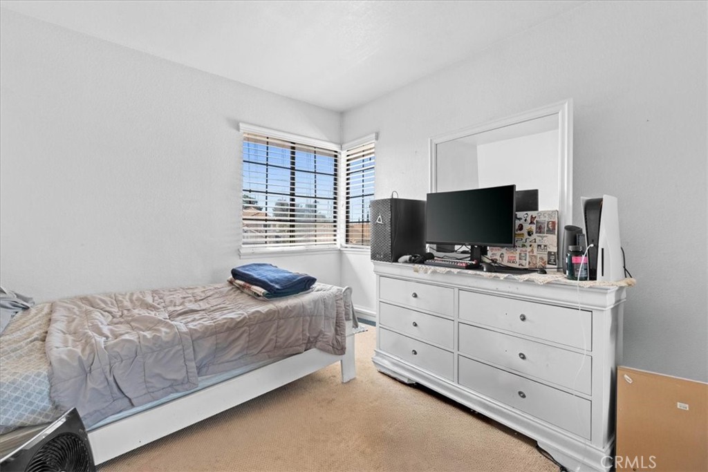 10536 Deerfield Drive Rancho Cucamonga, CA 91701 - Photo 21 of 28 a bedroom with a bed and flat screen tv
