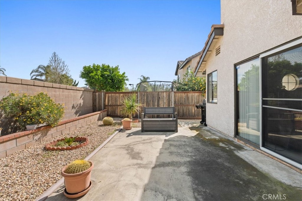 10536 Deerfield Drive Rancho Cucamonga, CA 91701 - Photo 23 of 28 a view of a patio with a chairs and potted plants