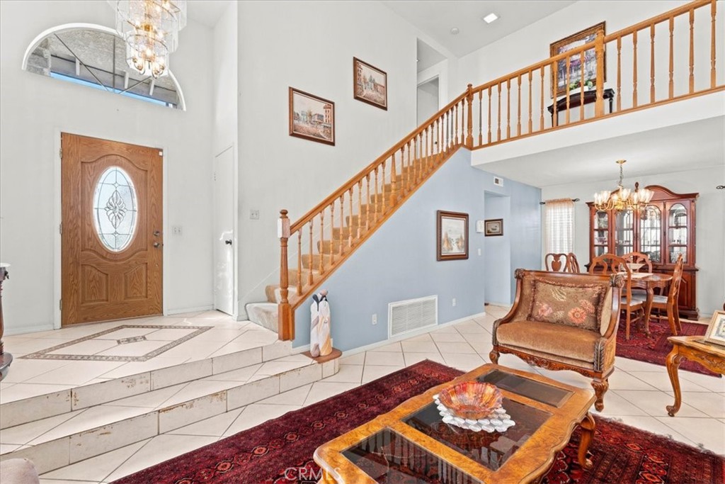 10536 Deerfield Drive Rancho Cucamonga, CA 91701 - Photo 3 of 28 a living room with furniture a rug and a clock