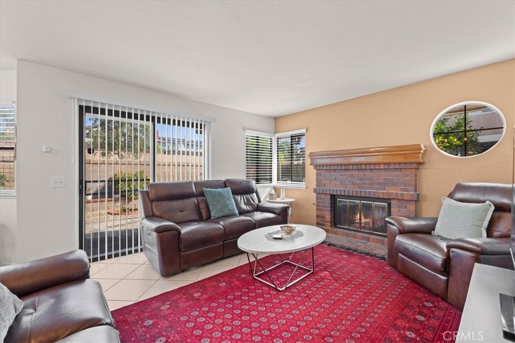 10536 Deerfield Drive Rancho Cucamonga, CA 91701 - Photo 6 of 28 a living room with furniture a rug and a floor to ceiling window