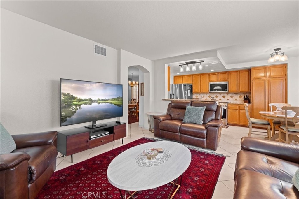10536 Deerfield Drive Rancho Cucamonga, CA 91701 - Photo 7 of 28 a living room with furniture and a flat screen tv