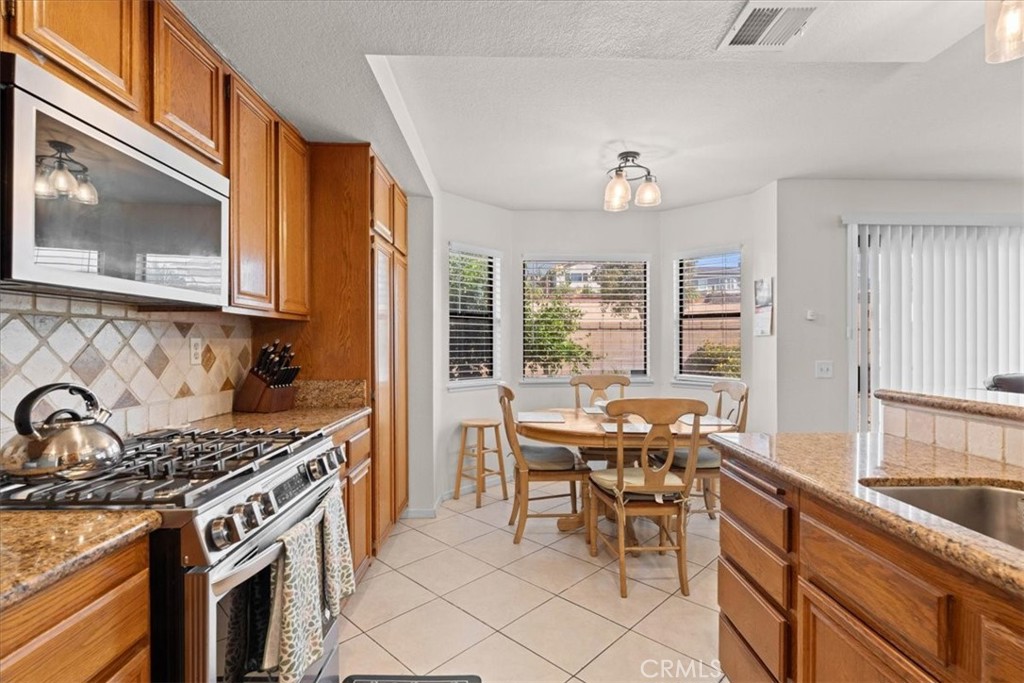 10536 Deerfield Drive Rancho Cucamonga, CA 91701 - Photo 10 of 28 a kitchen with a stove and a sink