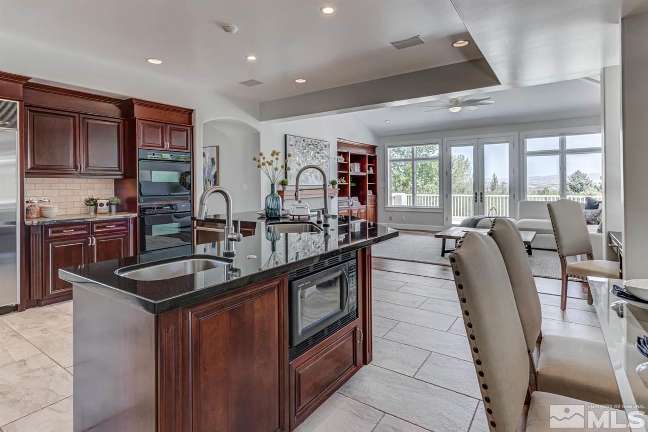 25 Promontory Pointe Reno, NV 89519 - Photo 11 of 40 a kitchen with stainless steel appliances granite countertop a sink a stove and a refrigerator