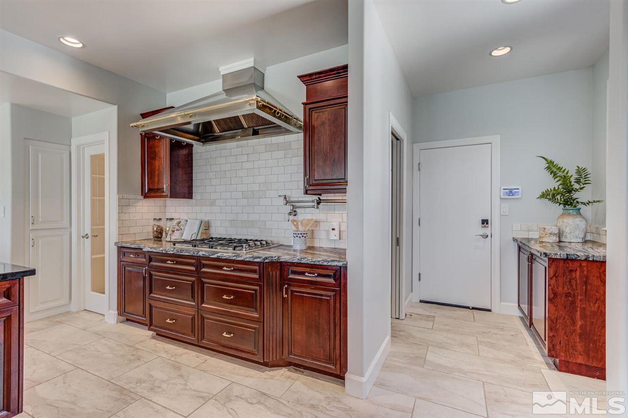 25 Promontory Pointe Reno, NV 89519 - Photo 12 of 40 a kitchen with stainless steel appliances granite countertop a stove and a sink