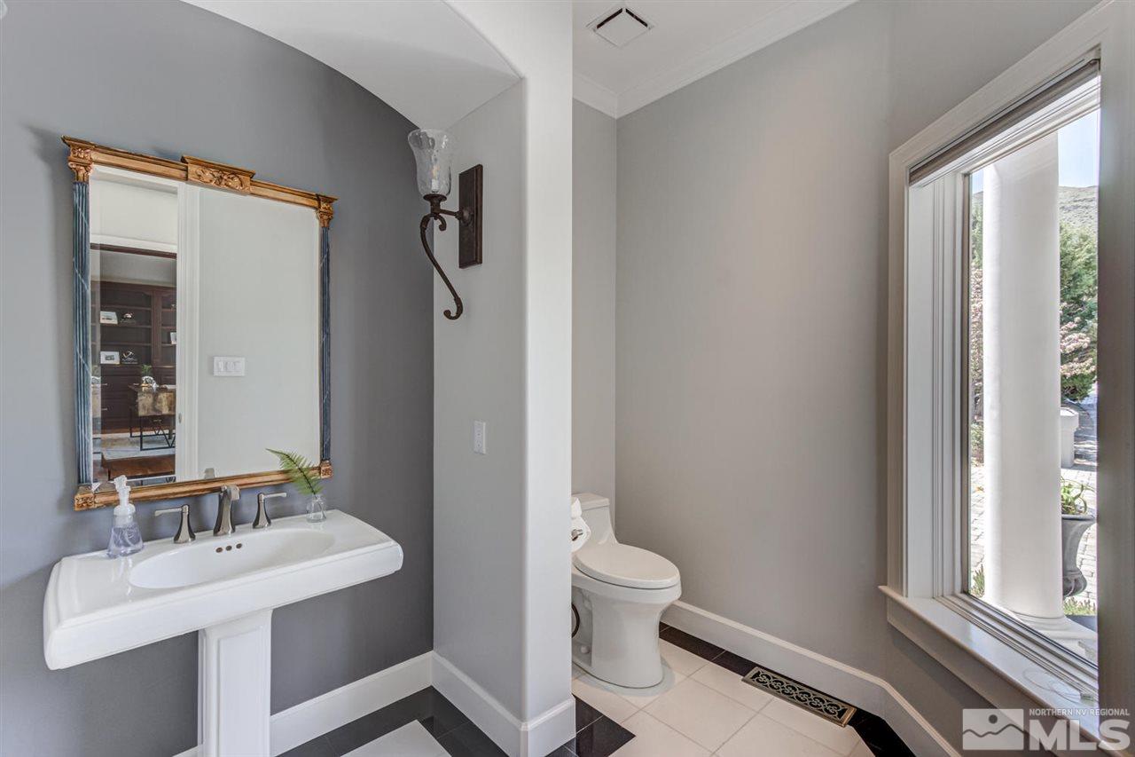 25 Promontory Pointe Reno, NV 89519 - Photo 16 of 40 a bathroom with a toilet sink and mirror