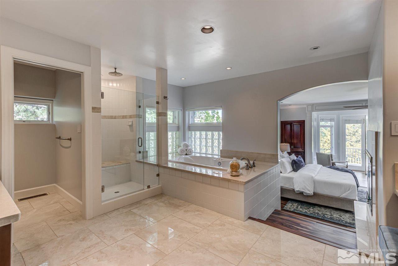 25 Promontory Pointe Reno, NV 89519 - Photo 19 of 40 a spacious bedroom with a bed and glass door