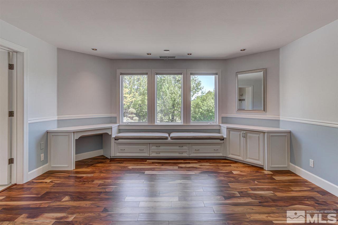 25 Promontory Pointe Reno, NV 89519 - Photo 24 of 40 a view of an empty room with a fireplace and wooden floor