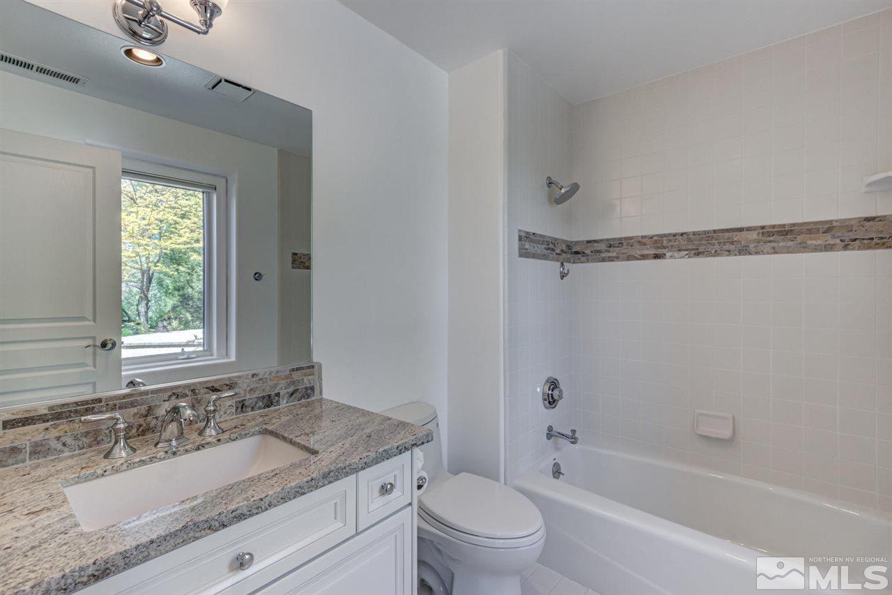 25 Promontory Pointe Reno, NV 89519 - Photo 26 of 40 a bathroom with a granite countertop sink a mirror toilet and bathtub