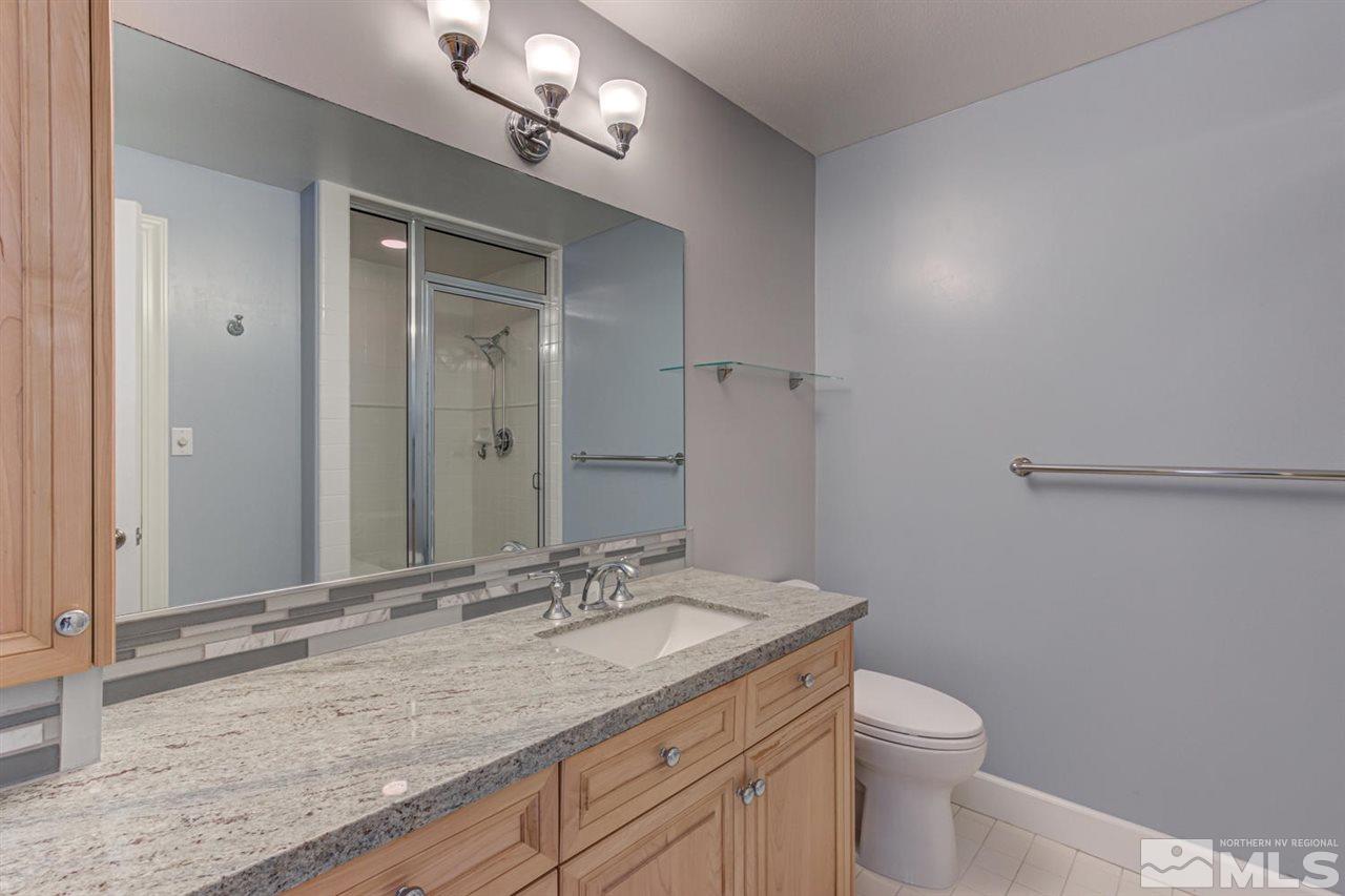 25 Promontory Pointe Reno, NV 89519 - Photo 28 of 40 a bathroom with a granite countertop sink a toilet and a mirror