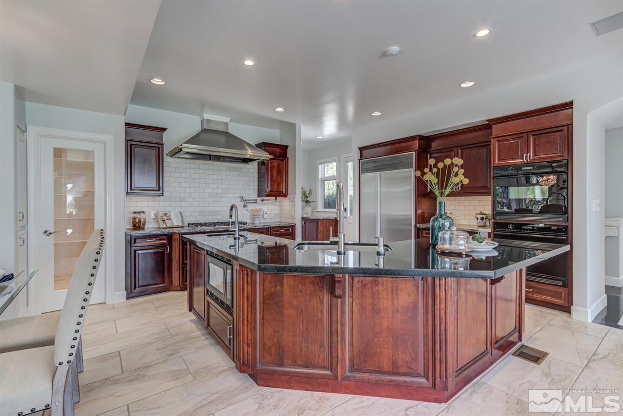 25 Promontory Pointe Reno, NV 89519 - Photo 8 of 40 a kitchen with stainless steel appliances granite countertop a stove a sink and a refrigerator