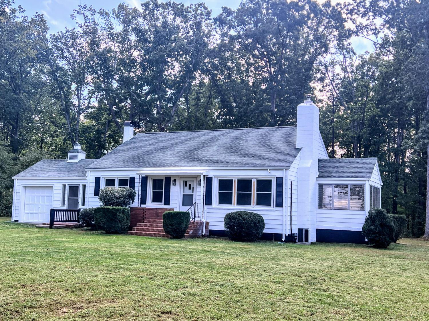198 Woodbridge Lane Spout Spring, VA 24593 - Photo 1 of 27 a front view of a house with a garden and trees