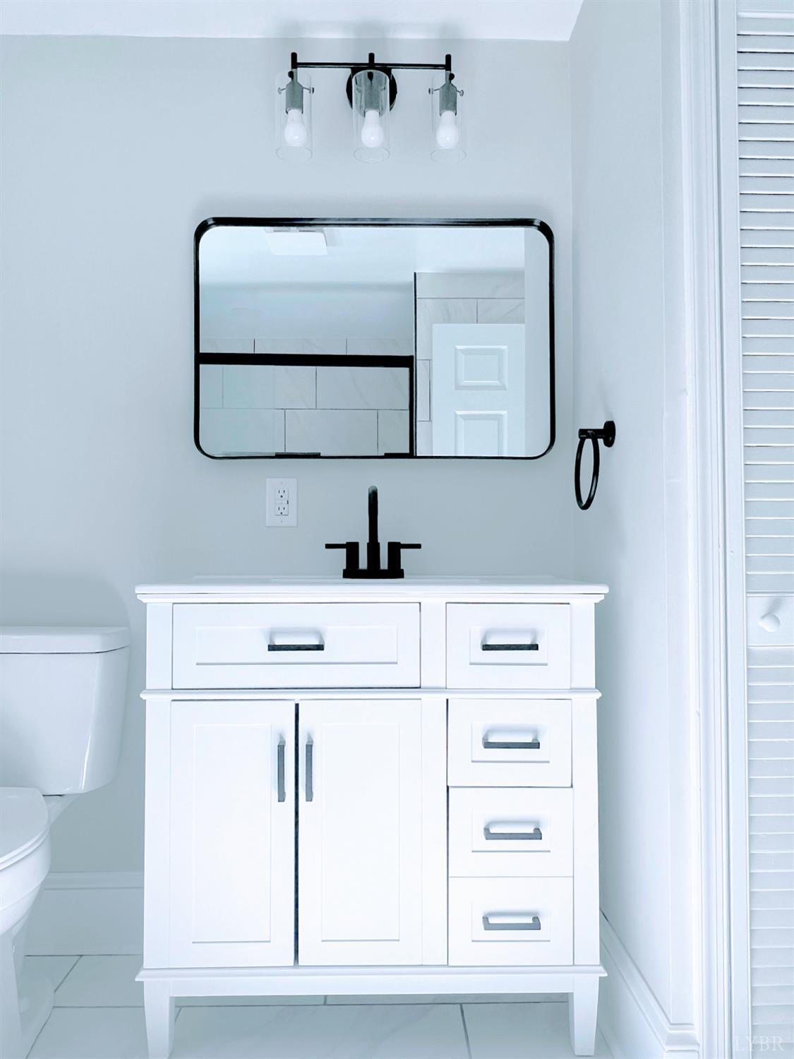 198 Woodbridge Lane Spout Spring, VA 24593 - Photo 13 of 27 a bathroom with a sink and a mirror