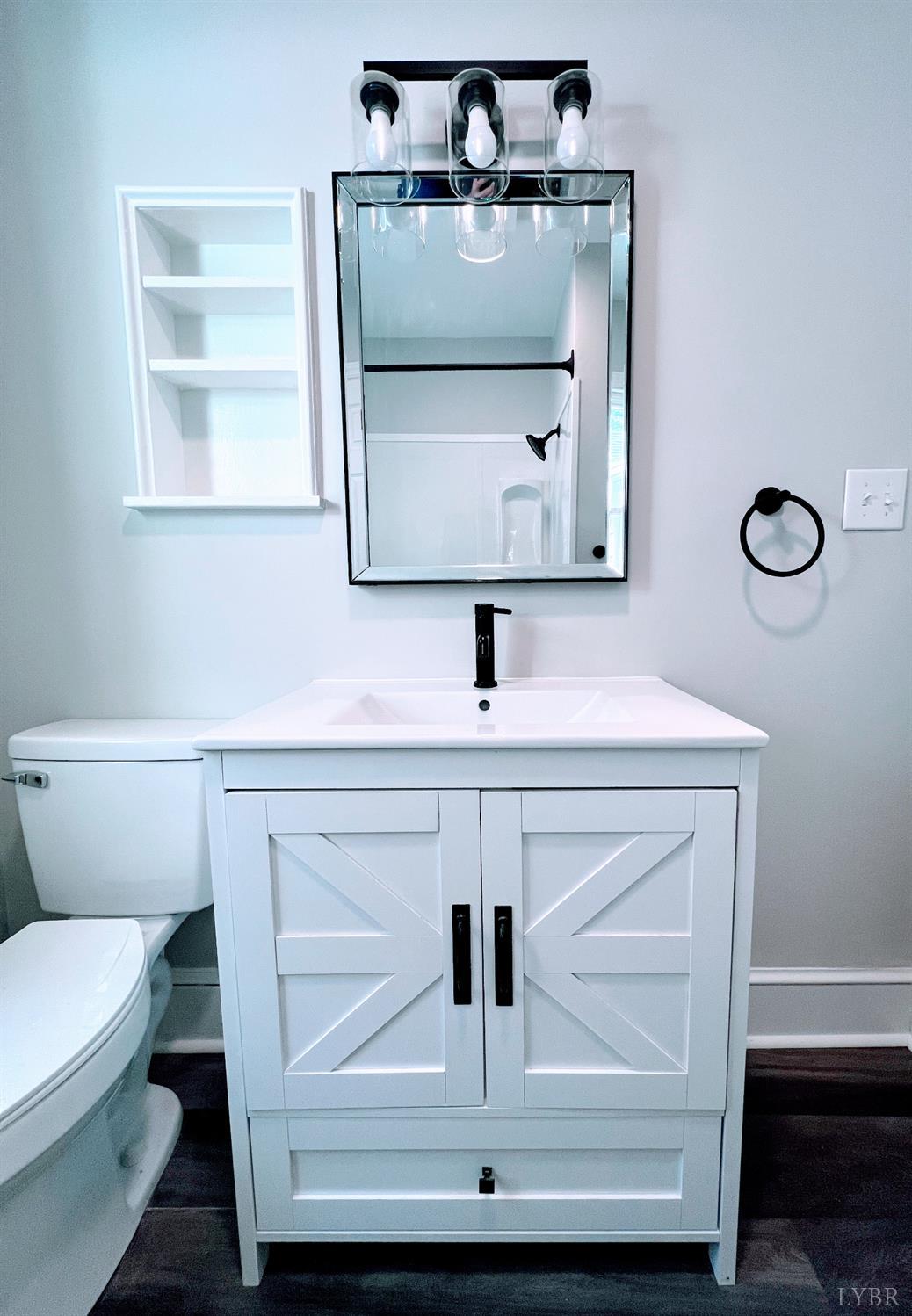 198 Woodbridge Lane Spout Spring, VA 24593 - Photo 17 of 27 a bathroom with a sink toilet and mirror