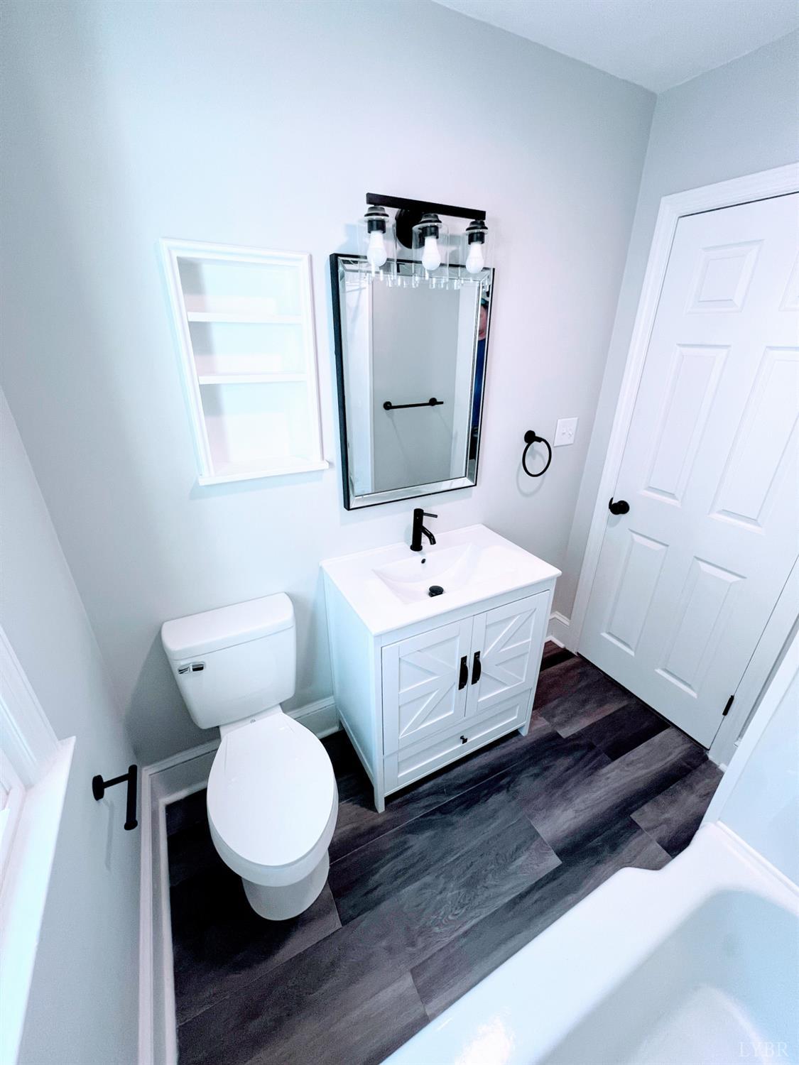198 Woodbridge Lane Spout Spring, VA 24593 - Photo 18 of 27 a bathroom with a toilet sink and mirror