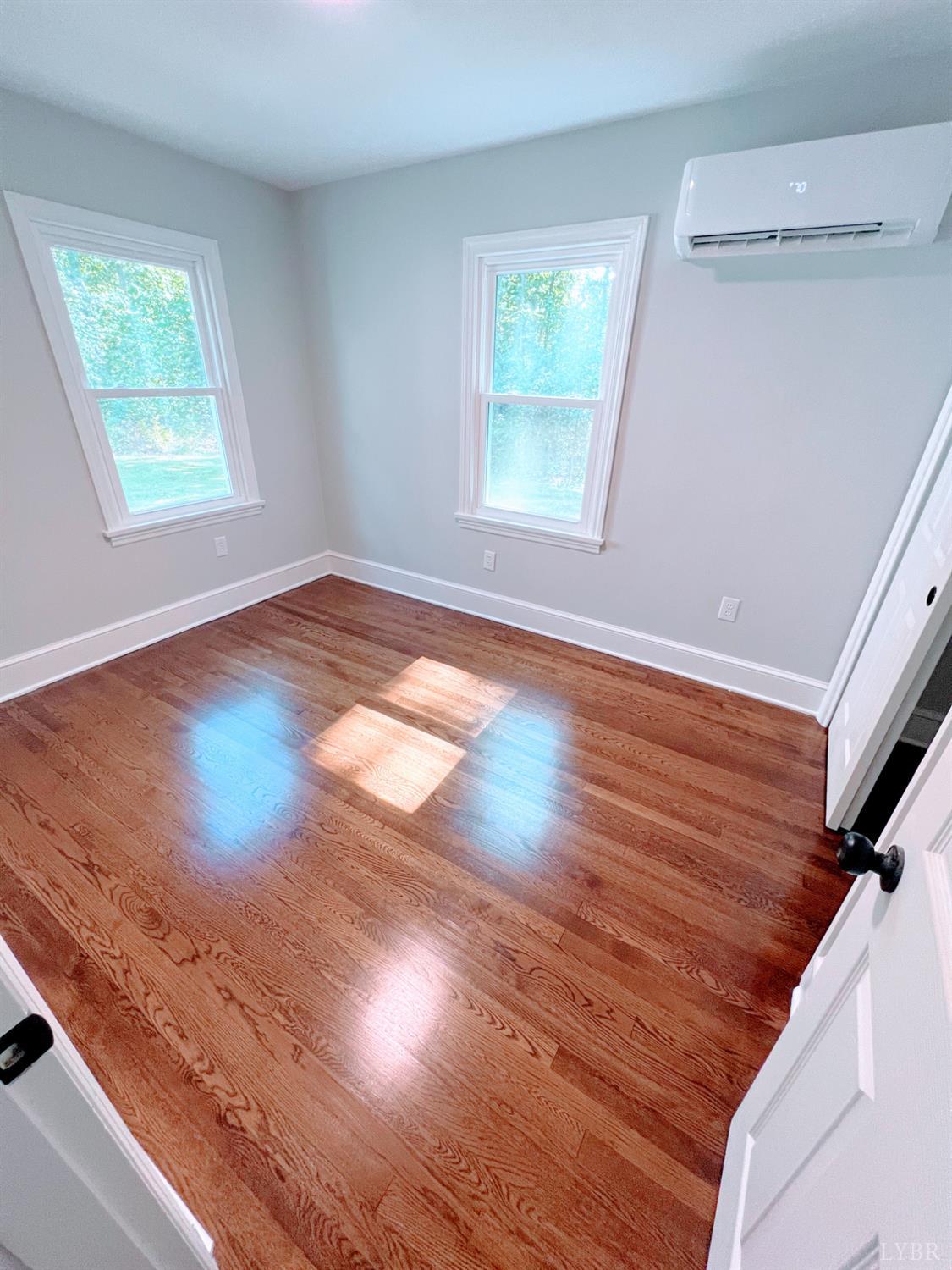 198 Woodbridge Lane Spout Spring, VA 24593 - Photo 21 of 27 a view of empty room with wooden floor and fan