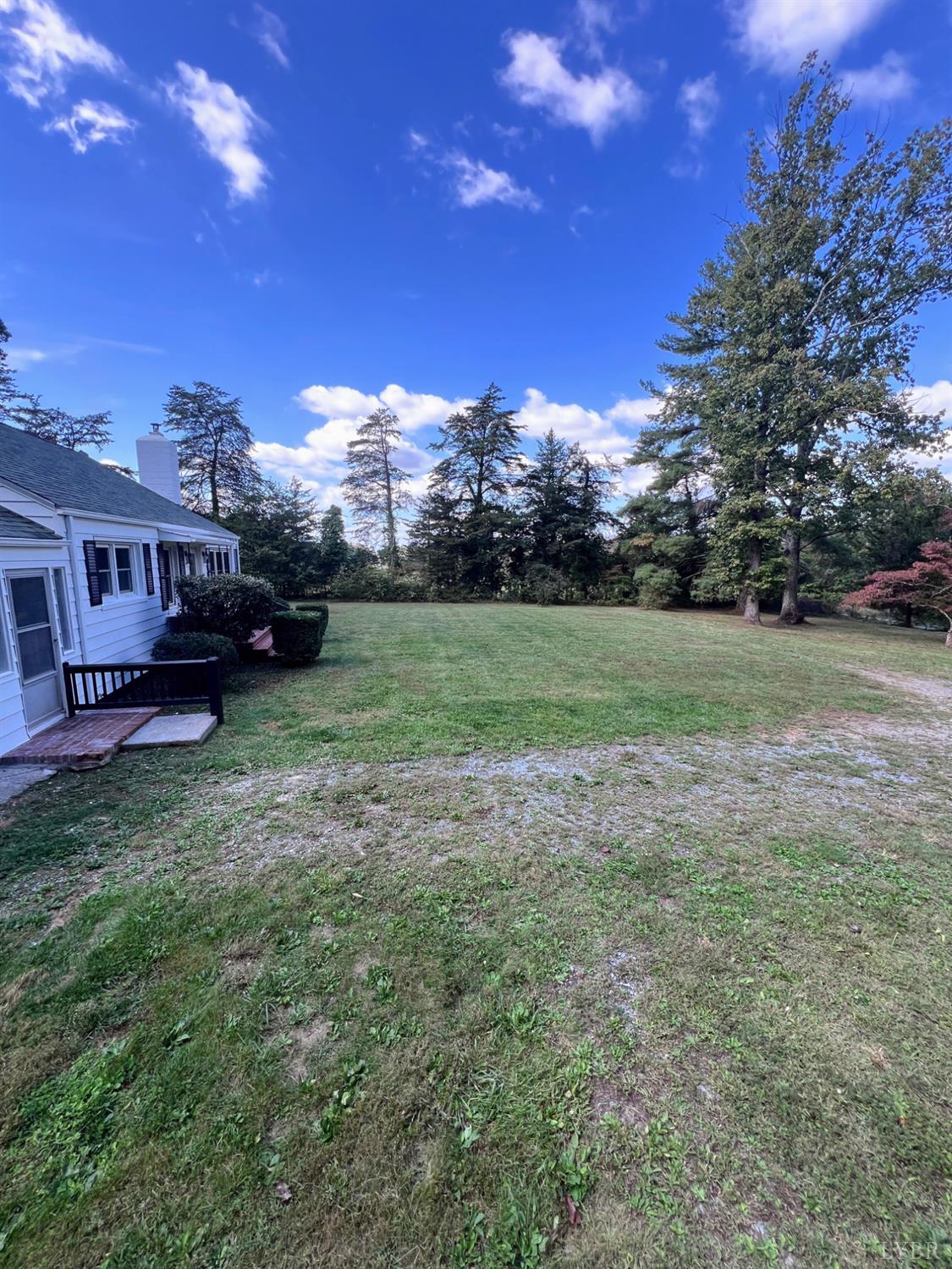 198 Woodbridge Lane Spout Spring, VA 24593 - Photo 25 of 27 a view of a big yard with a house in the background