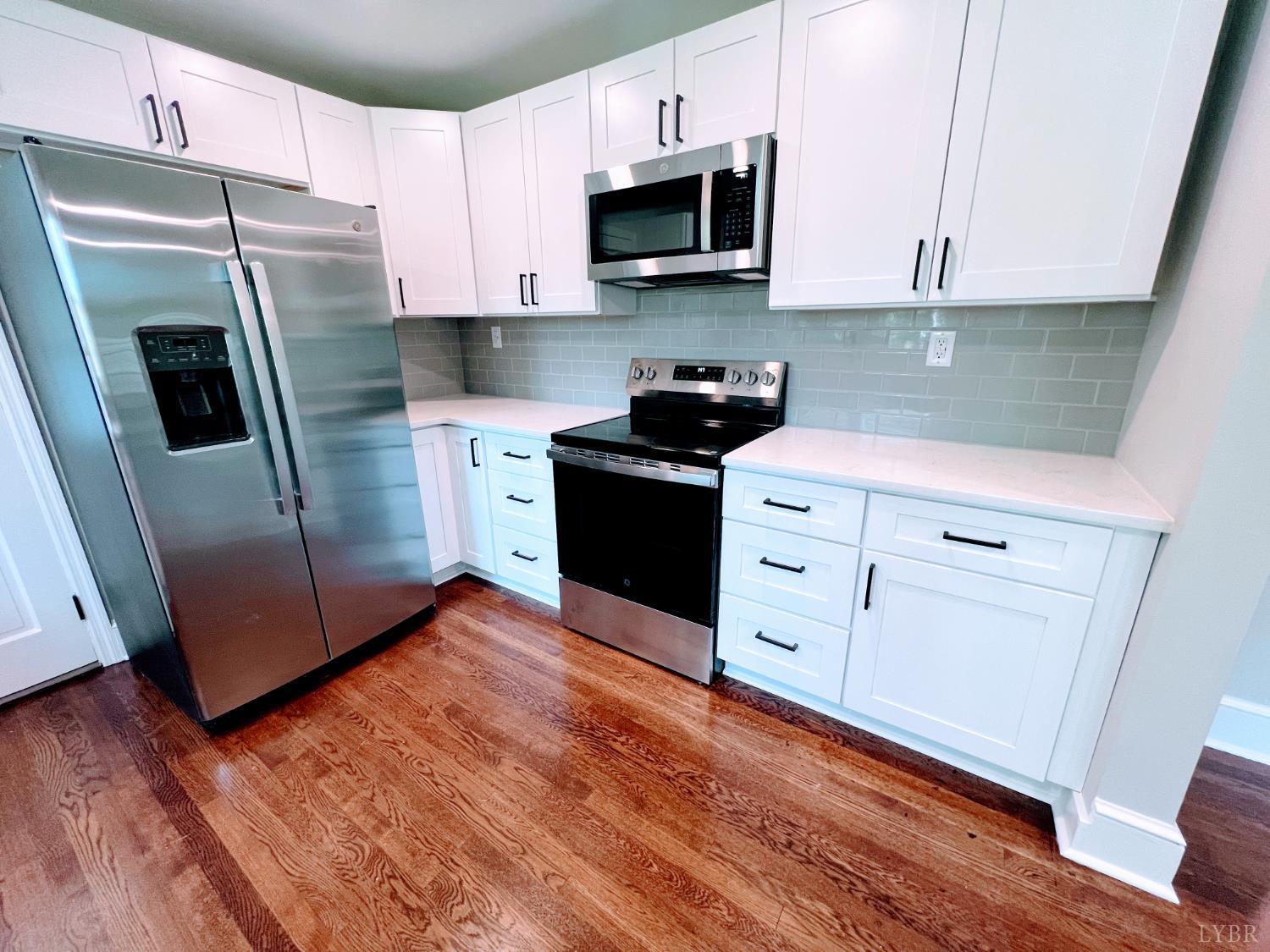 198 Woodbridge Lane Spout Spring, VA 24593 - Photo 5 of 27 a kitchen with stainless steel appliances a refrigerator sink and microwave