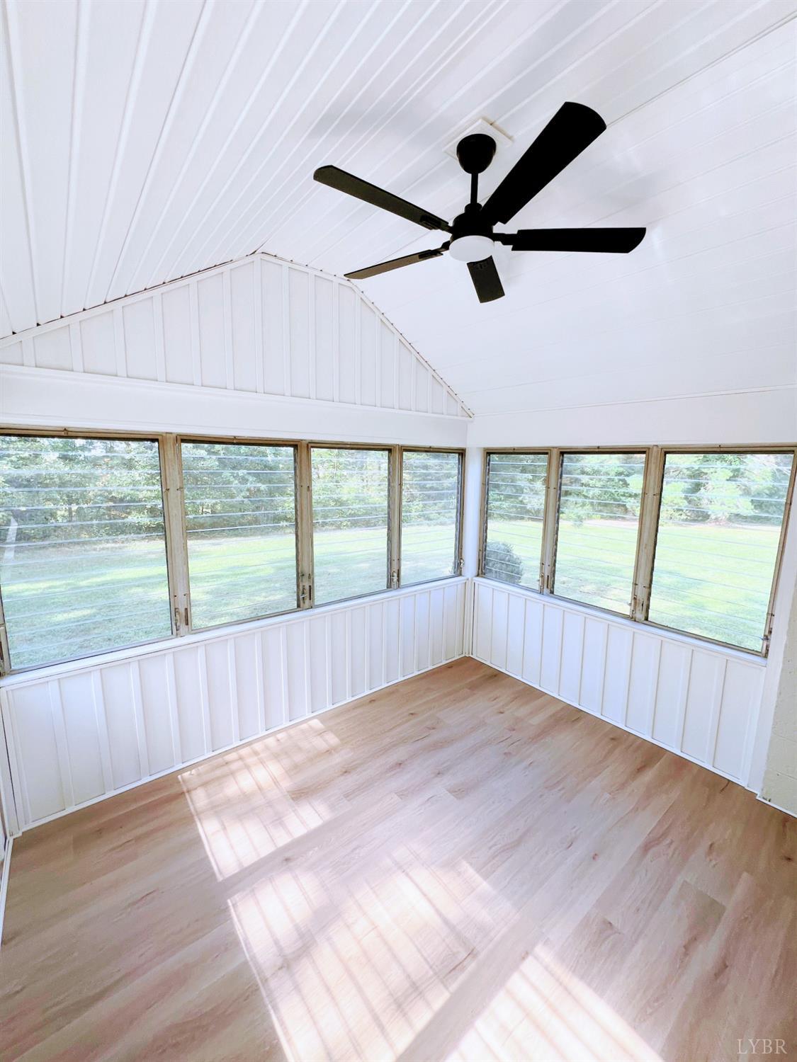 198 Woodbridge Lane Spout Spring, VA 24593 - Photo 10 of 27 an empty room with wooden floor and windows