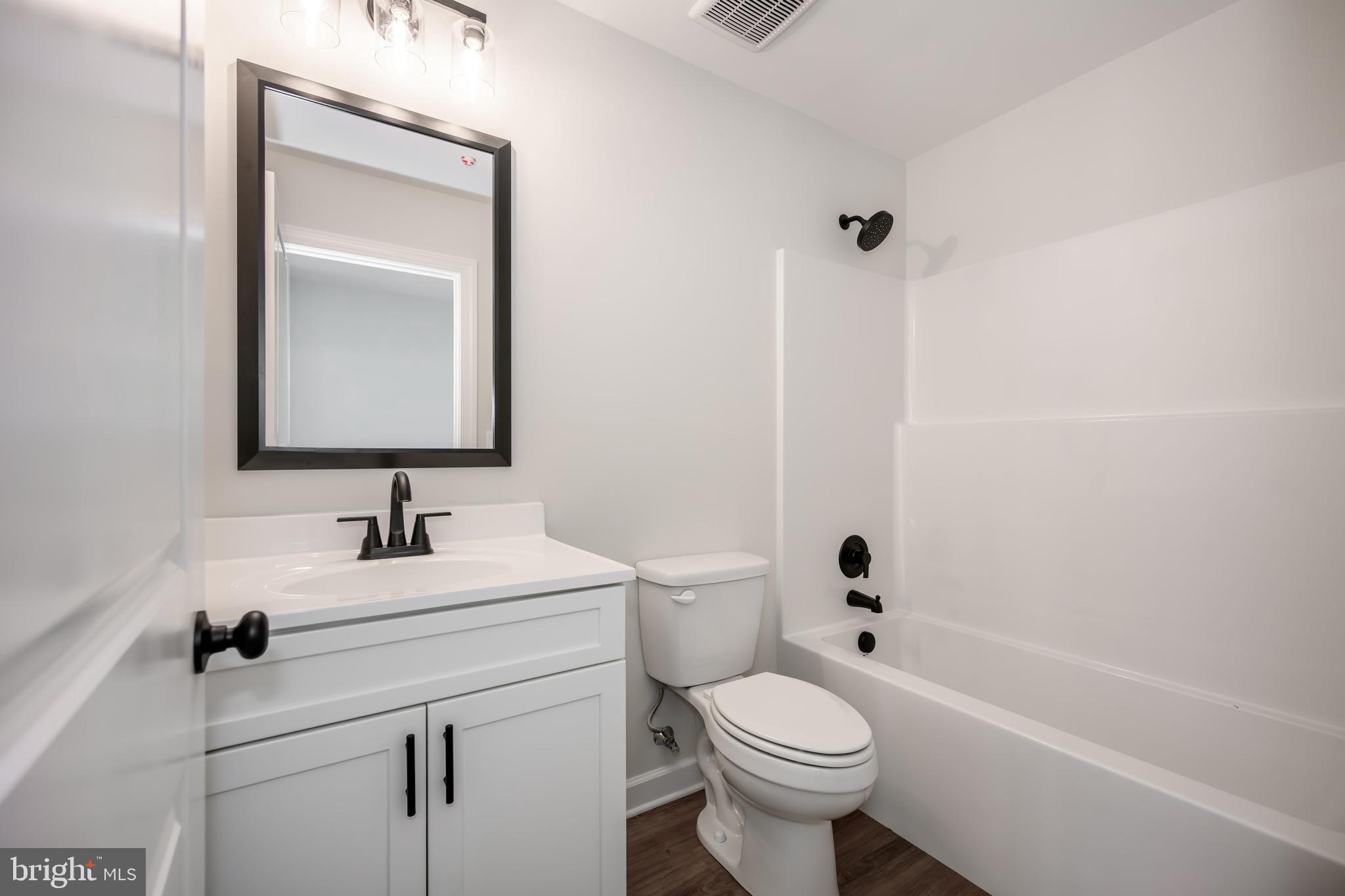 132 Spring Street Centreville, MD 21617 - Photo 13 of 19 a bathroom with a sink toilet vanity and tub