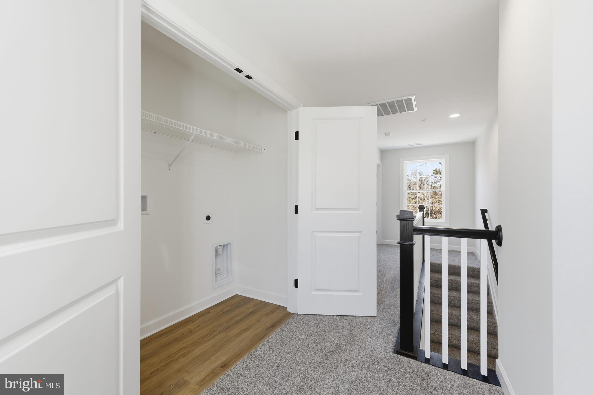 132 Spring Street Centreville, MD 21617 - Photo 16 of 19 a view of a hallway with wooden floor and staircase