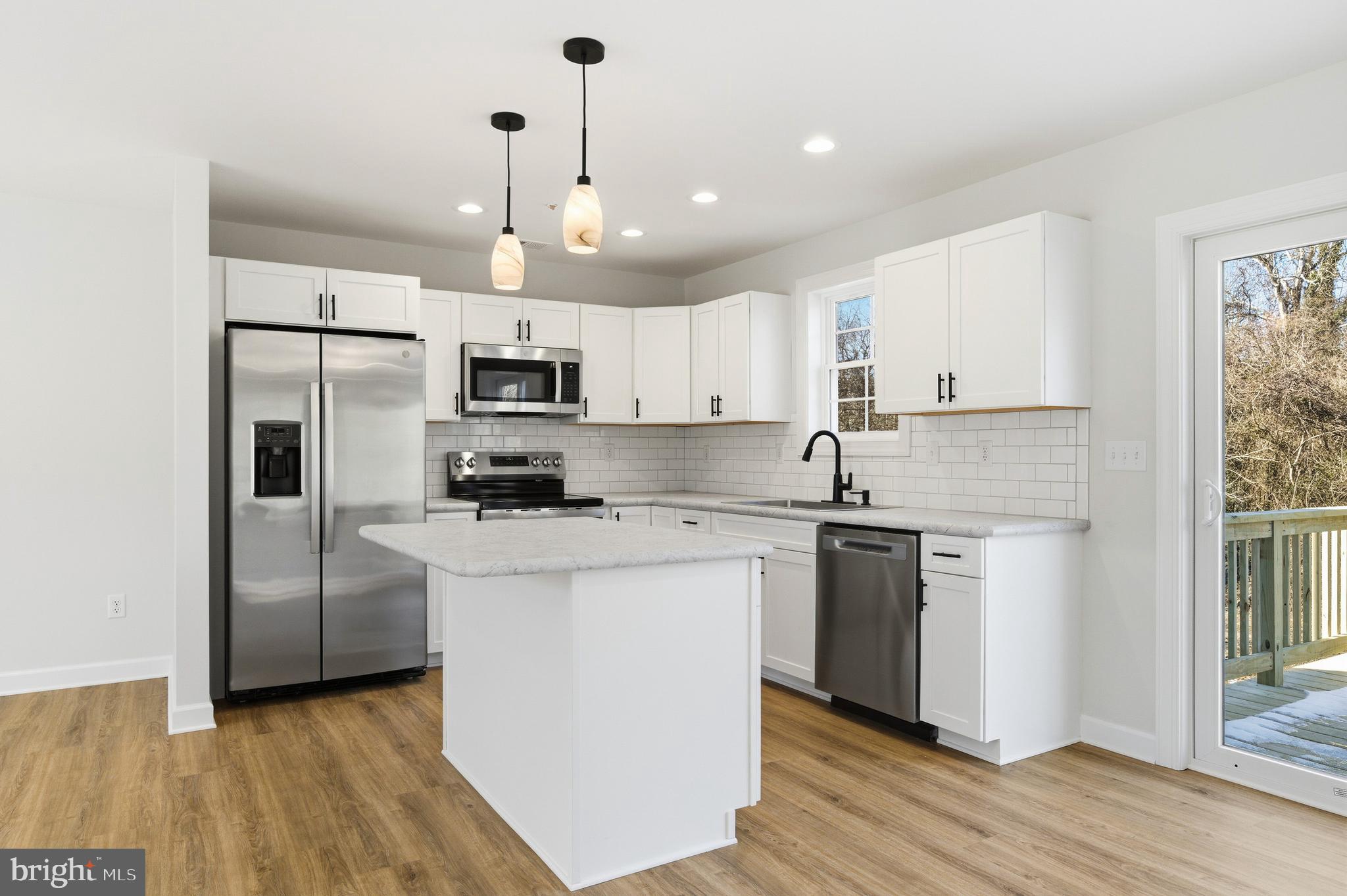 132 Spring Street Centreville, MD 21617 - Photo 4 of 19 a kitchen with cabinets stainless steel appliances and a window