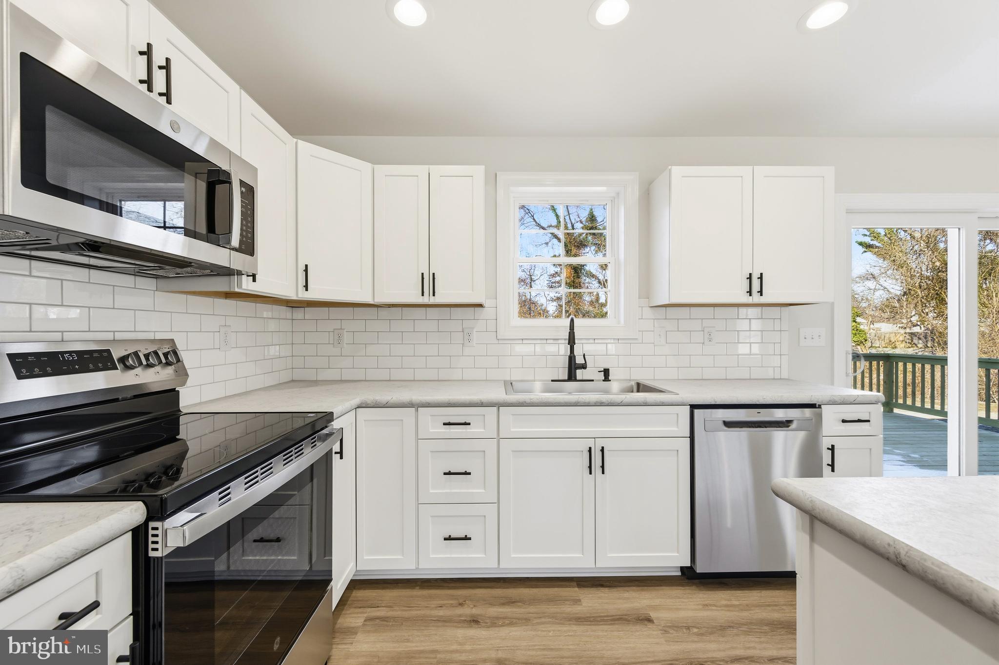 132 Spring Street Centreville, MD 21617 - Photo 5 of 19 a kitchen with stainless steel appliances granite countertop a stove microwave and cabinets