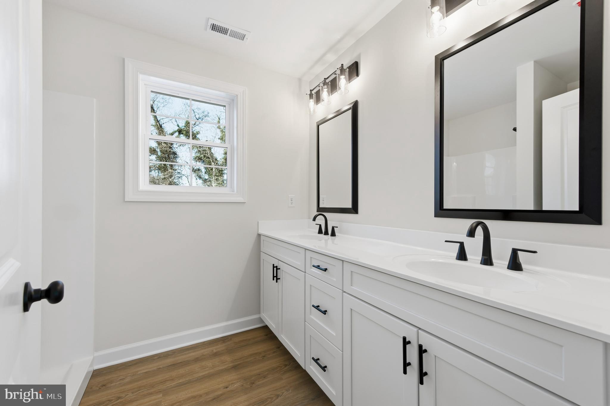 132 Spring Street Centreville, MD 21617 - Photo 8 of 19 a bathroom with 2 sink and a mirror