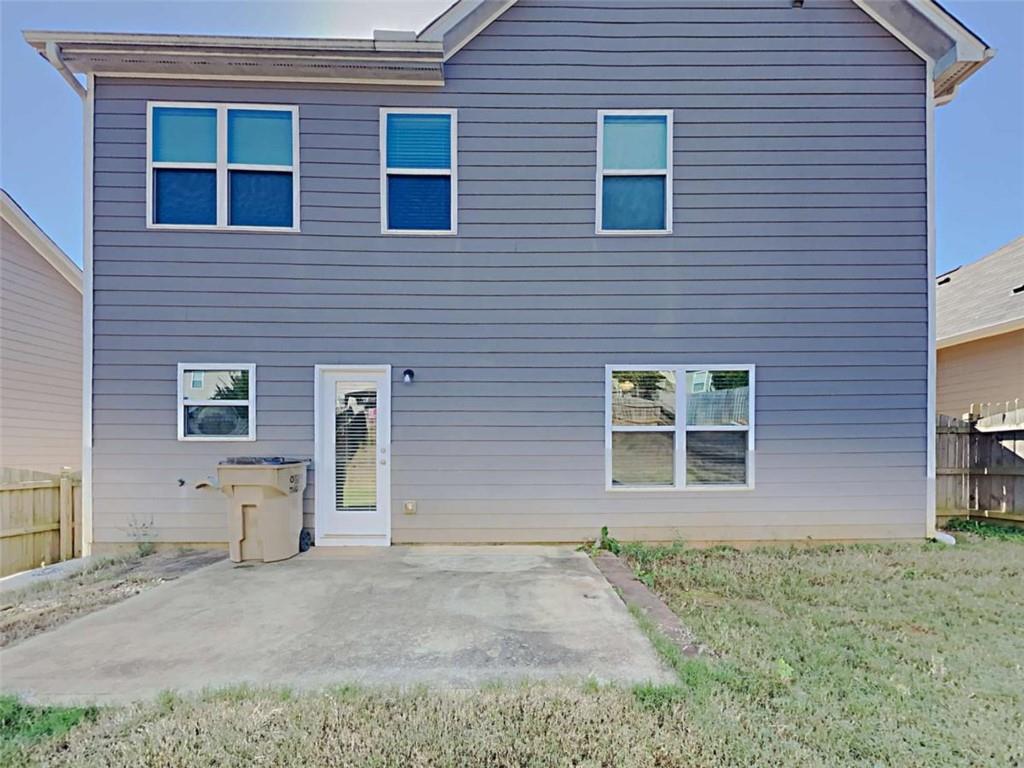 421 Reinhardt Lane Ball Ground, GA 30107 - Photo 2 of 22 a view of a brick house with large windows and a yard
