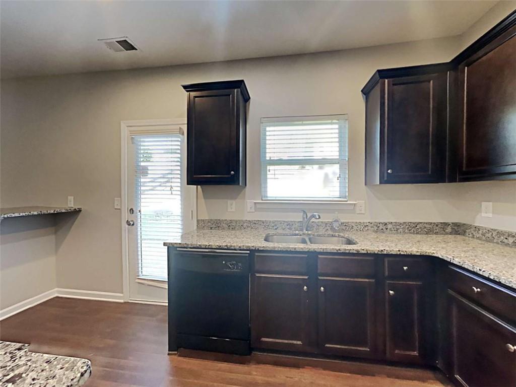 421 Reinhardt Lane Ball Ground, GA 30107 - Photo 5 of 22 a kitchen with granite countertop a sink cabinets and wooden floor