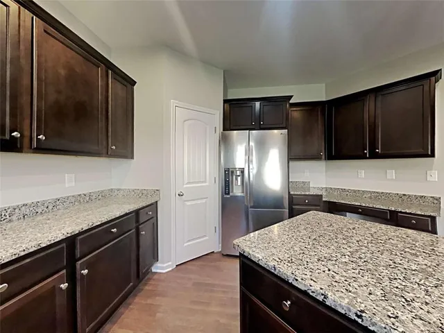 a kitchen with a sink refrigerator and microwave
