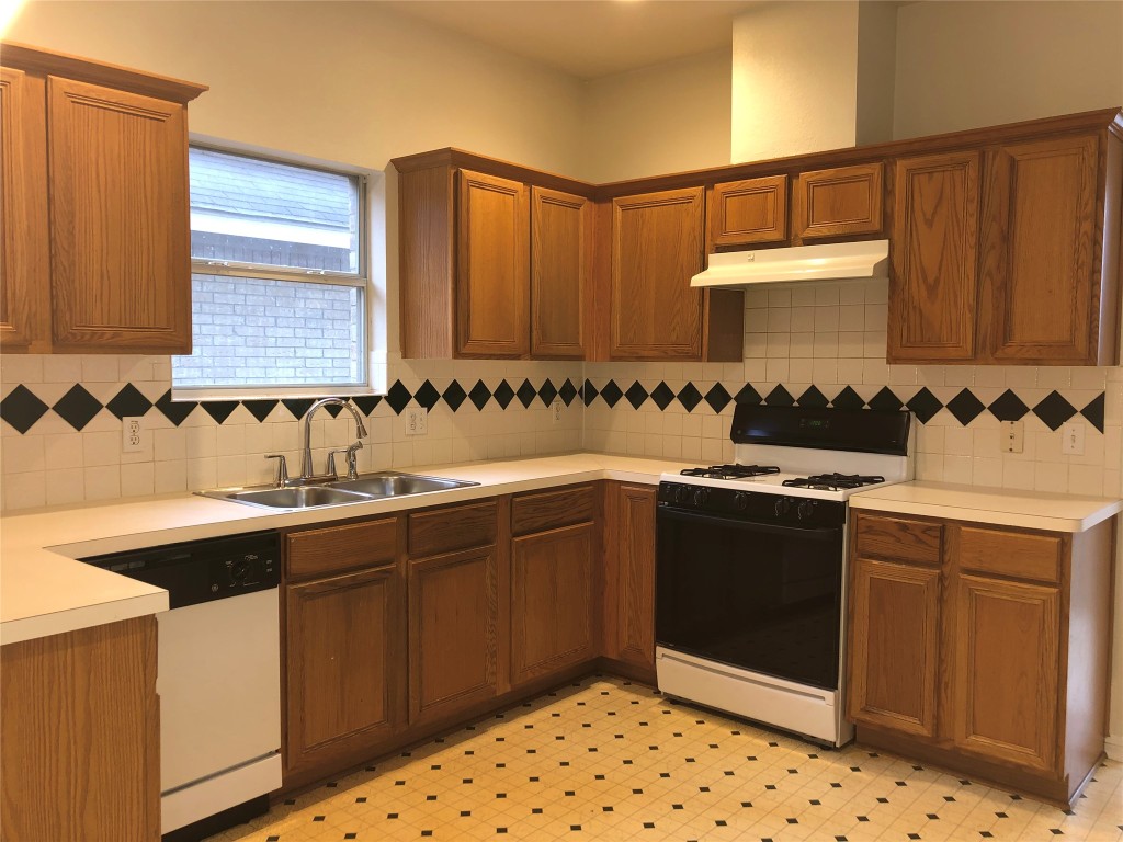 3604 Roller Crossing Austin, TX 78728 - Photo 22 of 40 Kitchen featuring gas range oven, light countertops, light floors, and brown cabinetry