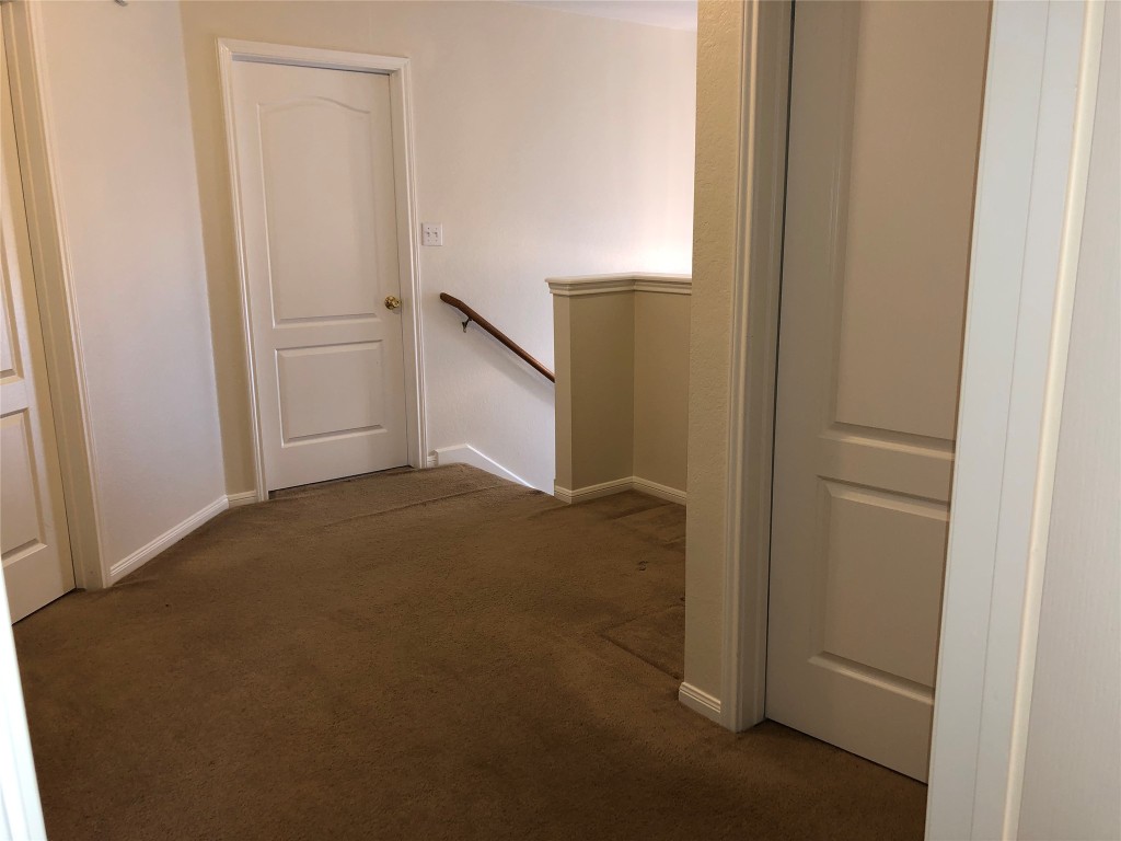 3604 Roller Crossing Austin, TX 78728 - Photo 28 of 40 Hall with an upstairs landing and dark carpet