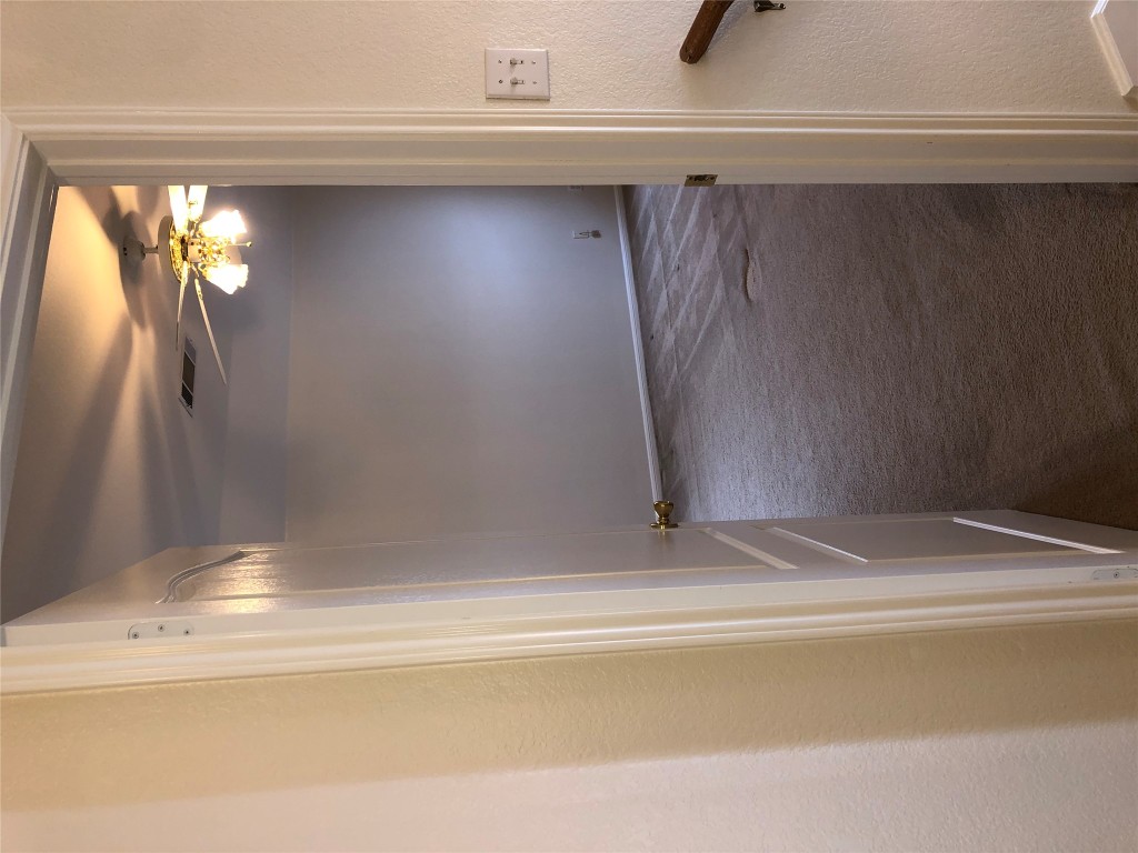 3604 Roller Crossing Austin, TX 78728 - Photo 29 of 40 Hall with dark colored carpet and a textured wall