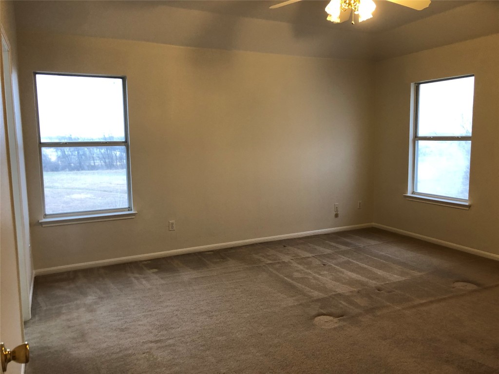 3604 Roller Crossing Austin, TX 78728 - Photo 30 of 40 Unfurnished room featuring dark carpet and a ceiling fan