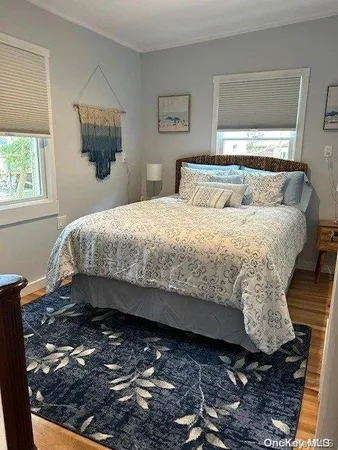 a bed sitting in a bedroom next to a window