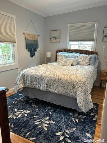 a bed sitting in a bedroom next to a window